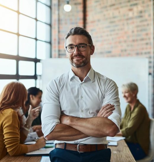 Nothing can break our team Cropped shot of a businessman standing in the office with his arms folded looking confident and smiling at the camera